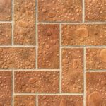 Close-up of wet brick tiles with water droplets, showcasing a textured pattern ideal for backgrounds.