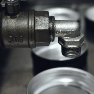 Detailed view of a rugged metal pipe fitting in an industrial setting.